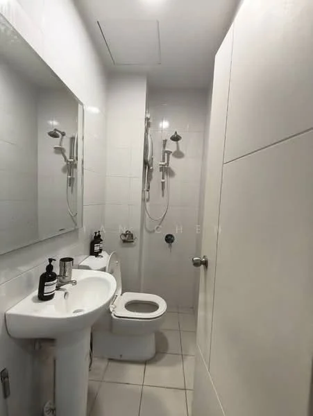 Bathroom features: white tiled walls, white ceramic floor tiles, single-sink vanity with mirror, chrome basin mixer faucet, toilet, shower with wall-mounted shower head, wall-mounted light fixtures, soap dispenser, toiletries on countertop; style: modern.