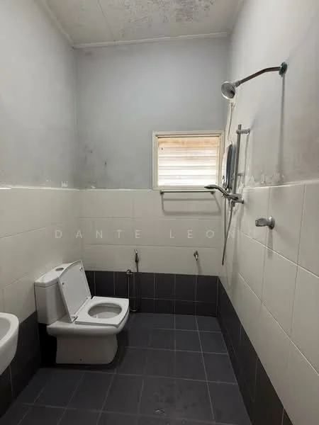 Bathroom features: white wall tiles, grey floor tiles, one-piece toilet, handheld shower, shower head, window for natural light, chrome shower rail, wall-mounted faucet.