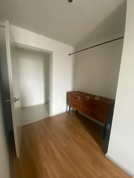 Room features: white painted walls, laminate flooring, wooden dresser with drawers, door leading to another room, ceiling light fixture, hanging rod for clothing; style: modern.