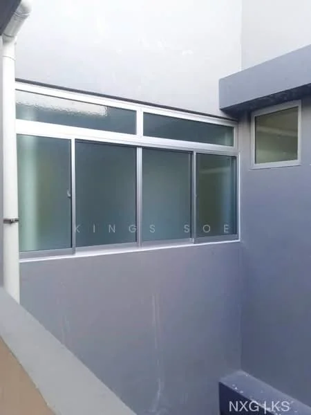 Room features: grey painted walls, large glass windows, metal window frames, frosted glass panels, concrete flooring, corner wall, natural light from windows; style: modern.
