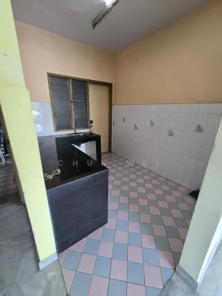 Kitchen features: black countertop, checkerboard tile flooring in pink and white, white tiled walls, window with metal grilles, single-bowl sink, kitchen island, light fixture on ceiling, yellow painted walls.