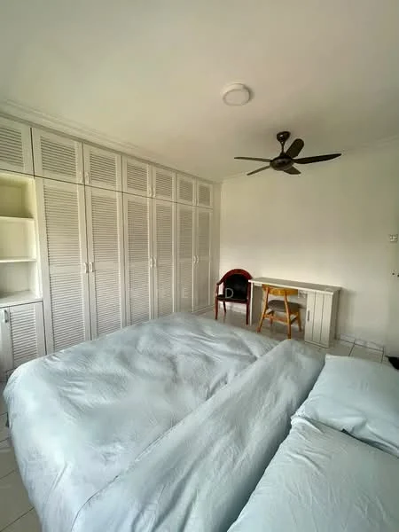 Bedroom features: king-size bed with light blue bedding, ceiling fan, built-in wardrobe with louvered doors, study desk, wooden chair, white walls, tile flooring, natural light from window; style: minimalist.