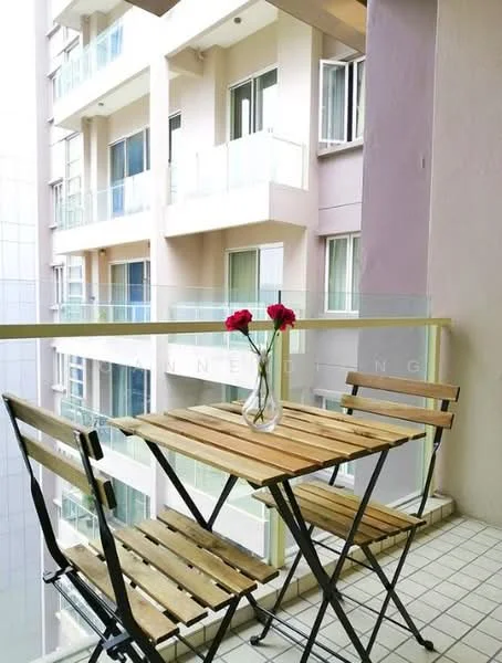 Balcony features: wooden folding table, two wooden folding chairs, glass railing, tile flooring, vase with flowers; view: city.