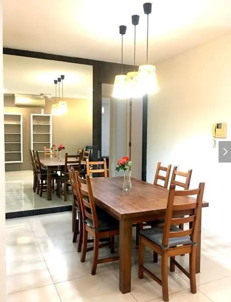 Dining features: wooden dining table, 6 wooden dining chairs, pendant lighting fixtures, mirror wall, cream painted walls, tile flooring, air conditioning unit, decorative flower vase; style: modern.