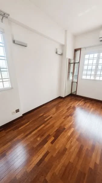 Room features: wooden flooring, white painted walls, floor-to-ceiling windows, 2 wall-mounted split ACs, mirror on wall, natural light from windows.