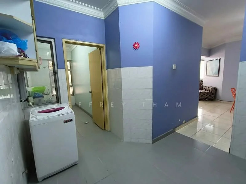 Laundry features: front-load washing machine, white cabinetry, grey tiled flooring, blue painted walls, white tiled walls, crown moulding, doorway to hallway, window for natural light; style: modern. Living features: sofa in patterned fabric, orange plastic dining chair, white tiled flooring, blue painted walls, decorative wall art, natural light from window, open layout to hallway; style: modern.
