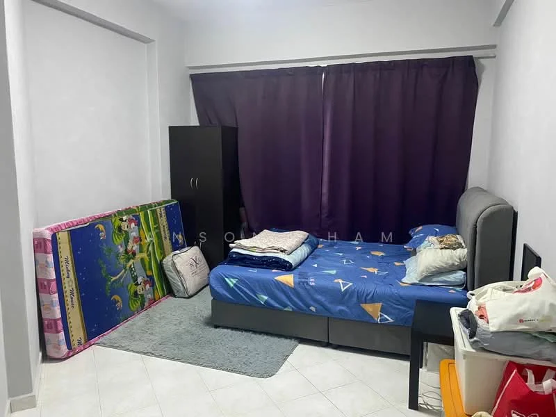 Bedroom features: grey upholstered bed, blue bedspread with geometric pattern, white pillows, purple curtains, white walls, light grey carpet, black wardrobe, mattress on floor, decorative cushions, area rug.