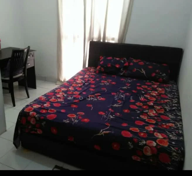 Bedroom features: queen-size bed with floral bedding, black upholstered bed frame, two decorative pillows, white walls, tile flooring, window with sheer curtains, desk with chair, desk lamp.