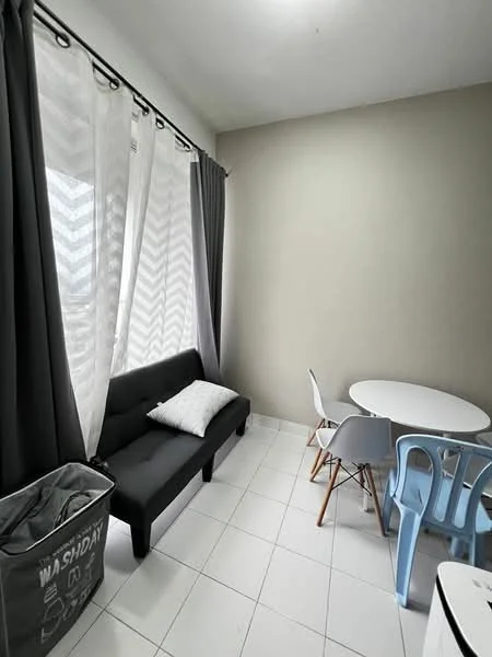 Room features: grey fabric sofa, white round dining table, 4 dining chairs in various colors, floor-to-ceiling windows with sheer curtains, white tiled flooring, light grey painted walls, decorative cushion on sofa, waste bin with 'WASHDAY' text; style: modern.