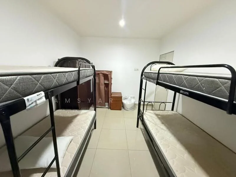 Room features: two sets of metal bunk beds, mattresses on beds, cream-colored walls, tile flooring, single wooden dresser, white trash bin, wooden cabinet, overhead ceiling light; style: minimalist.
