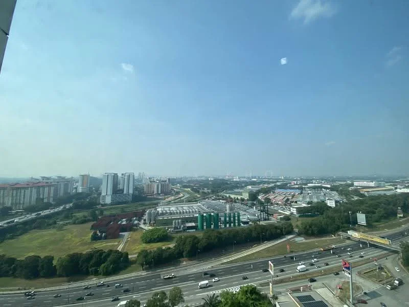 Exterior type: high-rise condominium; features: city skyline view, surrounded by greenery, main road visible, urban landscape, multiple high-rise buildings, open sky, traffic on road; style: modern.