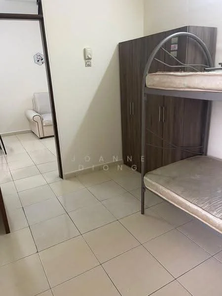 Room features: bunk bed with metal frame, mattress on top and bottom bunk, wooden wardrobe, cream tiled flooring, white painted walls, light switch on wall, doorway leading to another room, small armchair in background.