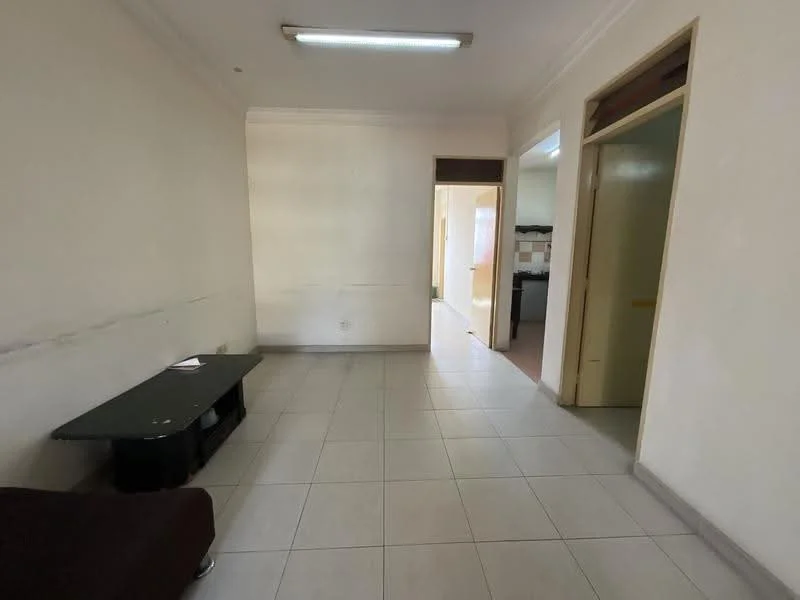Room features: white painted walls, tile flooring, ceiling light fixture, single door leading to hallway, window with no visible treatment, dark wood console table, neutral color scheme.