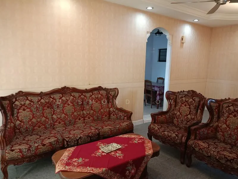 Living features: ornate wooden sofa set with red upholstery, two matching armchairs, coffee table with decorative cloth, cream wallpaper with floral pattern, recessed downlights, carpeted flooring, arched entryway, decorative wall paneling; style: traditional.