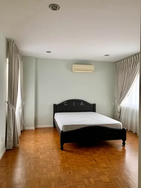 Bedroom features: parquet wood flooring, light green painted walls, white ceiling, 1 wall-mounted split AC, floor-to-ceiling windows with sheer curtains, black wooden bed frame without mattress, 2 ceiling lights.