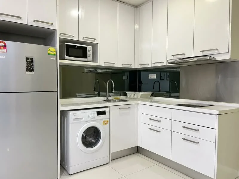 Kitchen features: white shaker cabinets, stainless-steel fridge, built-in microwave, single-bowl stainless-steel sink, chrome pull-down faucet, white countertop, ceramic tile flooring, built-in oven, washing machine, recessed downlights, mirror backsplash; style: modern.
