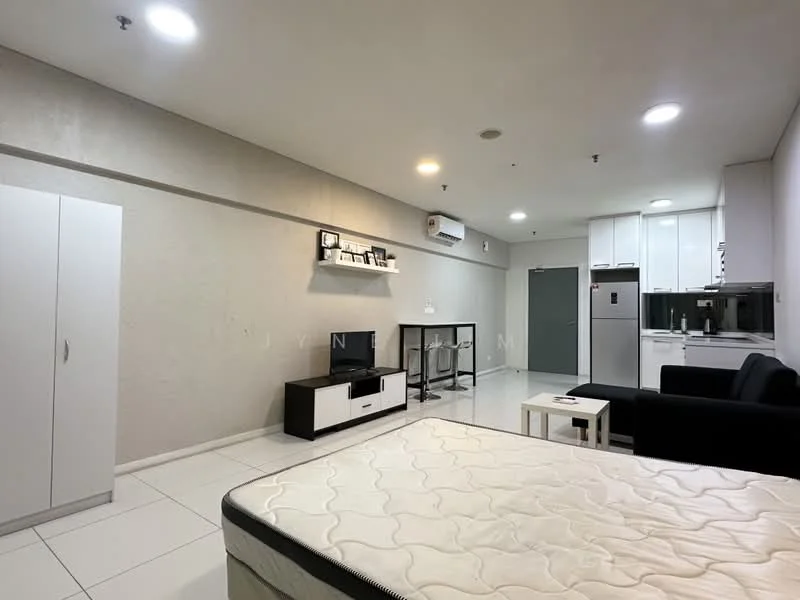 Living features: white painted walls, tile flooring, recessed downlights, wall-mounted split AC, black fabric sofa, white TV console, black and white coffee table, built-in cabinetry, kitchenette with white cabinets, stainless-steel fridge, open layout; style: modern.