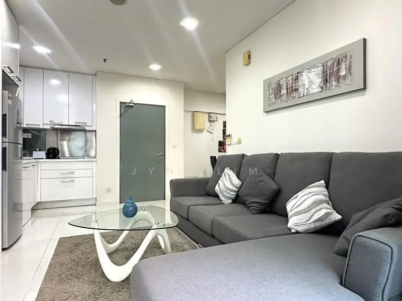 Living features: grey fabric sectional sofa, decorative throw pillows, glass coffee table, area rug with neutral color, white painted walls, recessed downlights, floor-to-ceiling windows, open-plan layout with kitchen, kitchen cabinetry in white, stainless-steel fridge, built-in oven, microwave, kitchen countertop, kitchen backsplash; style: modern.