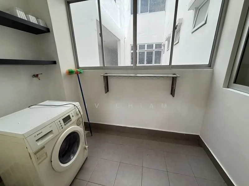 Laundry features: front-load washing machine in white, grey tiled flooring, white painted walls, shelf with black finish, window with multiple panes, metal drying rack, cleaning supplies on shelf, natural light from window.