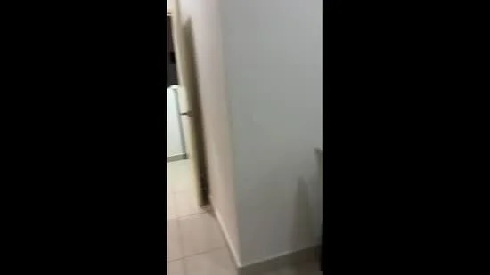 Room features: white painted walls, tile flooring, doorway, light switch, neutral color scheme.