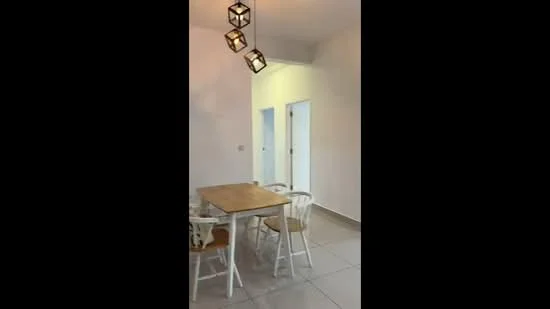 Dining features: square wooden dining table, 4 white wooden chairs, pendant light fixture with three bulbs, white painted walls, light grey tiled flooring, doorway leading to other rooms, neutral decor; style: modern.