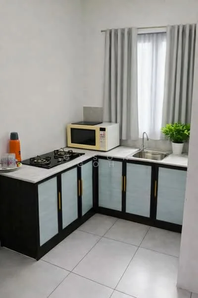 Kitchen features: L-shaped kitchen layout, white painted walls, grey tiled flooring, black cabinetry with gold handles, white countertop, stainless-steel sink, chrome faucet, 2-burner gas hob, microwave, window with sheer curtains, potted plant; style: modern.