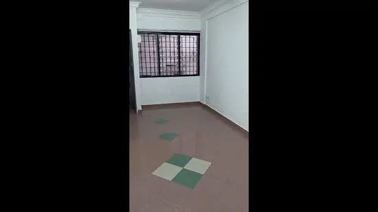Room features: white painted walls, tile flooring with green and cream accents, black metal window grilles, large window, natural light, corner room, plain ceiling, no visible furniture; style: minimalist.