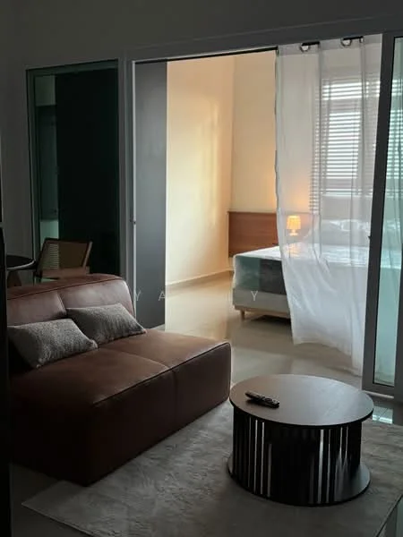 Living features: brown leather sofa, 2 cushions on sofa, round coffee table with black base, area rug, floor-to-ceiling glass sliding door, curtain for privacy, laminate flooring, wall-mounted TV remote on table; style: modern. Bedroom features: queen-size bed, wooden bed frame, nightstand with lamp, window with blinds, bedding visible; style: modern.