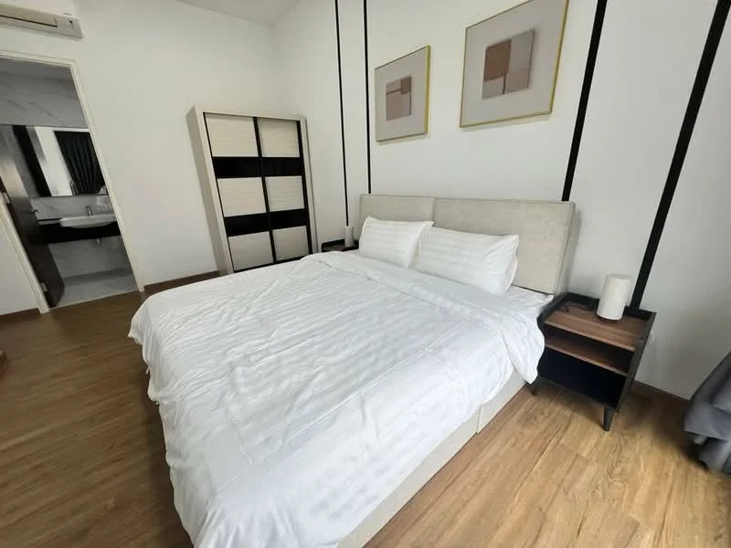 Bedroom features: king-size bed with white bedding, upholstered headboard, two bedside tables, table lamp on bedside table, built-in wardrobe with sliding doors, wooden flooring, wall-mounted split AC, framed artwork on walls, neutral wall color, black accent lines on walls; style: modern.