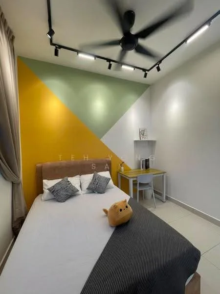 Bedroom features: queen-size bed with grey bedding, decorative throw pillows, geometric accent wall in yellow and green, white walls, ceiling fan with light, recessed LED downlights, small white desk, white chair, wooden flooring, plush toy on bed; style: modern.