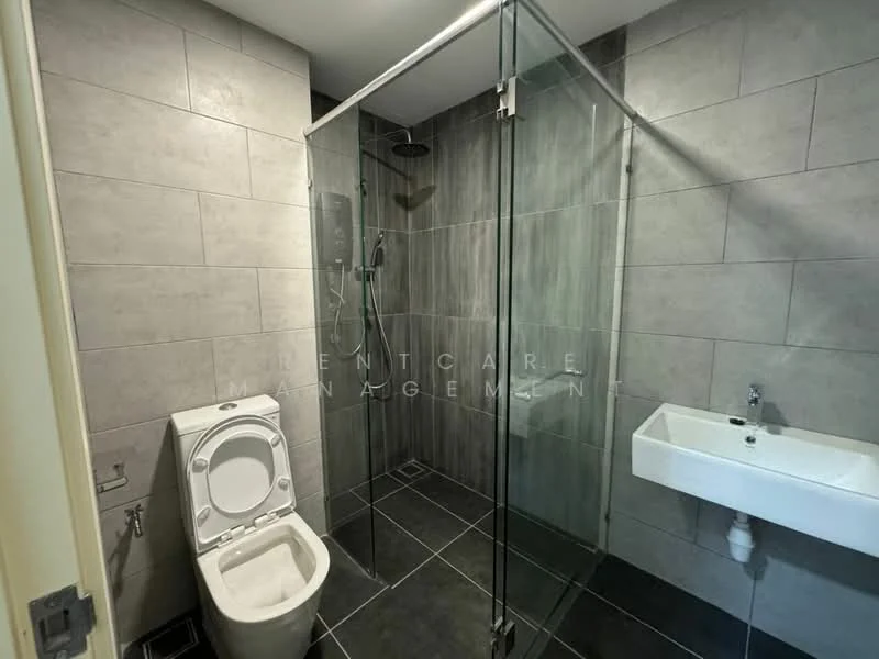 Bathroom features: glass shower enclosure, rain shower head, handheld shower, wall-mounted shower controls, toilet, wall-mounted sink, grey tile walls, dark tile flooring, chrome fixtures; style: modern.