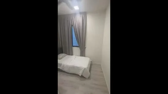 Bedroom features: single bed, white bedding, grey curtains, window with view, light-colored walls, laminate flooring, ceiling light, minimalist decor; style: modern.
