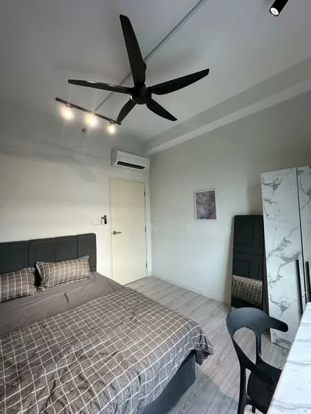 Bedroom features: king-size bed with grey upholstered headboard, bedding with checkered pattern, 5-blade ceiling fan with integrated LED light, wall-mounted split AC, light grey painted walls, laminate flooring, full-length mirror, study desk with chair; style: modern.