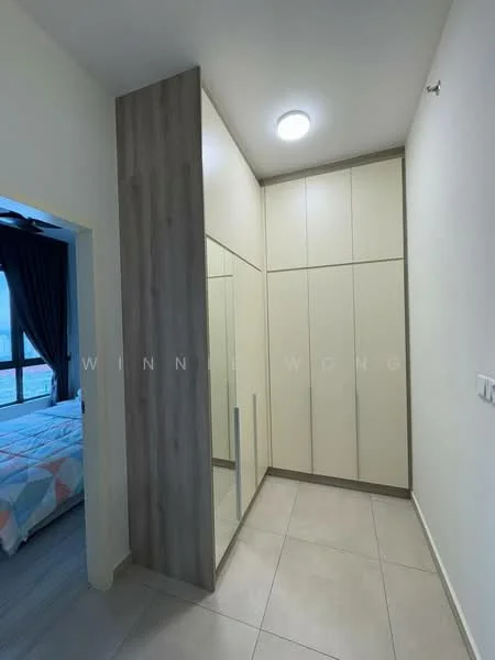 Room features: built-in wardrobe with mirrored doors, light-colored cabinetry, wood panel accent wall, recessed ceiling light, neutral tile flooring, corner wall with no visible windows, doorway leading to another room; style: modern.