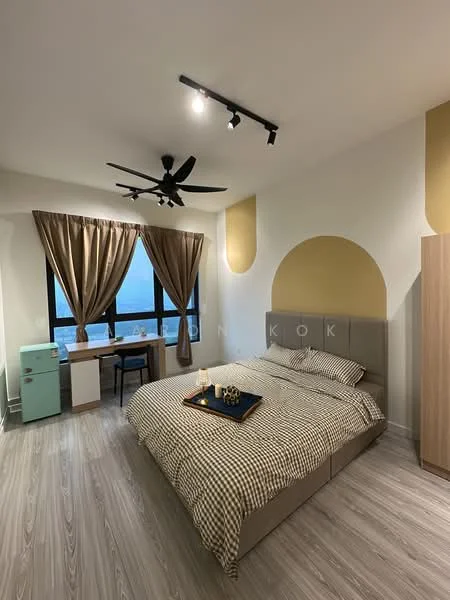Bedroom features: king-size bed with checkered bedding, upholstered headboard, 2 bedside lamps, wooden study desk, green fridge, floor-to-ceiling windows, curtains in beige, 5-blade ceiling fan with light, light wood flooring, accent wall in gold, decorative wall art; style: modern; view: city.