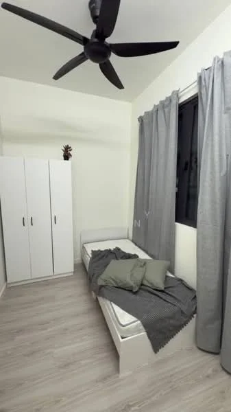Bedroom features: single bed, grey bedding, 2 green throw pillows, wooden flooring, white painted walls, floor-to-ceiling window, grey curtains, white wardrobe with 2 doors, ceiling fan; style: modern.