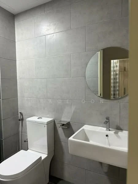 Bathroom features: grey tile cladding on walls, white wall-mounted sink, chrome faucet, round mirror, white one-piece toilet, shower hose with wall mount, grey tile flooring; style: modern.