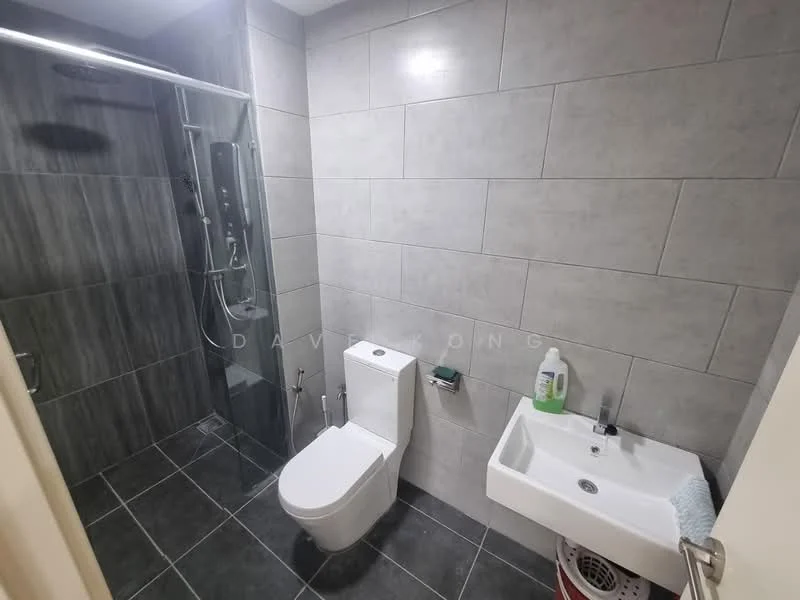 Bathroom features: walk-in shower with glass enclosure, chrome handheld shower, grey tile cladding on walls, dark grey floor tiles, one-piece toilet, single-sink vanity with white cabinet, chrome basin mixer, mirror above sink, towel rack, cleaning supplies visible; style: modern.