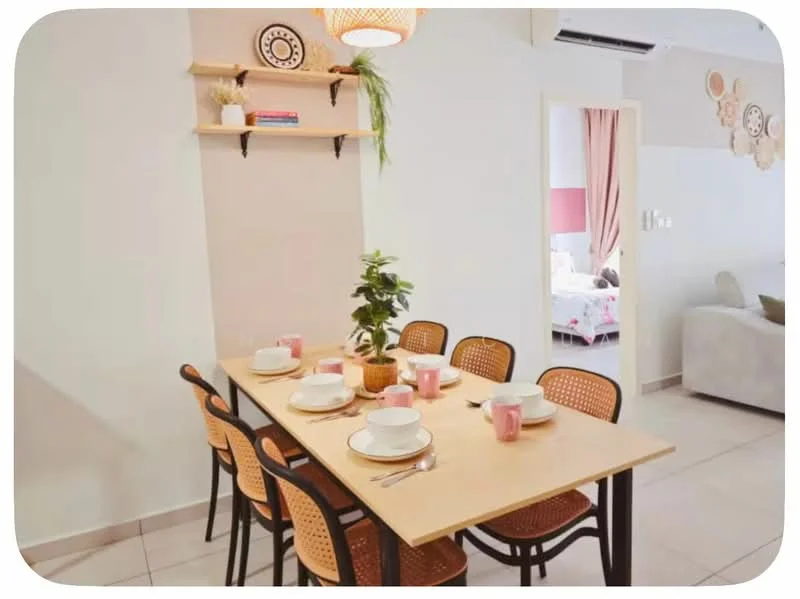 Dining features: 6-seater dining table, wooden table with light finish, black metal legs, woven rattan dining chairs, pink ceramic mugs, white plates, decorative plant in pot, shelf with books and decor, neutral wall color, tile flooring, air conditioning unit on ceiling; style: modern.