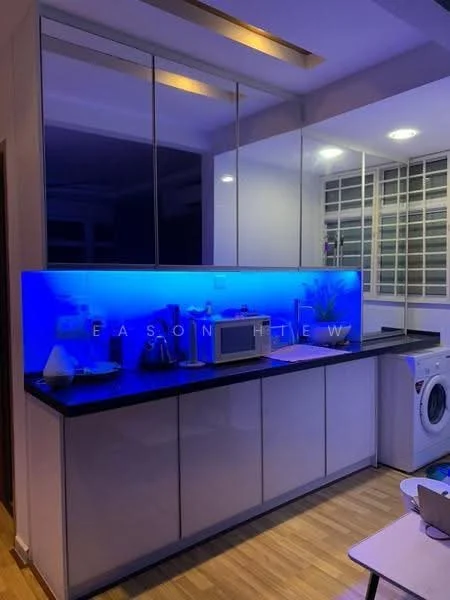 Kitchen features: white cabinetry, black countertop, blue LED backlighting, microwave, washing machine, stainless-steel sink, single-bowl sink, chrome faucet, glass splashback, wooden flooring, recessed ceiling lights, window with grid pattern; style: modern.