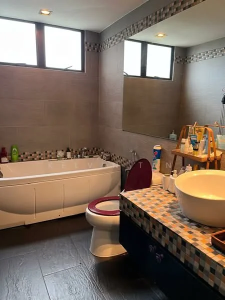 Bathroom features: freestanding bathtub, one-piece toilet, round vessel sink, countertop with mosaic tile, wall-mounted mirror, grey tiled walls, dark blue cabinetry, recessed lighting, window with grid pattern, shelf for toiletries, various toiletries visible; style: modern.
