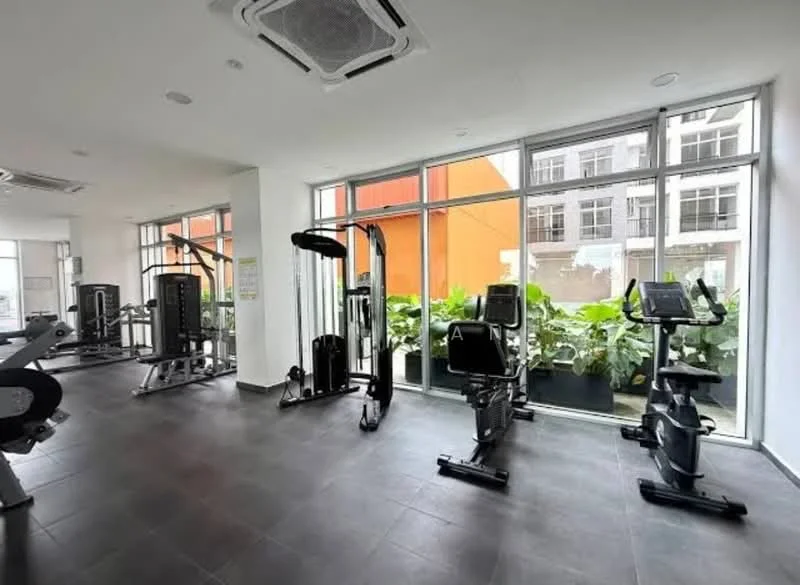 Room features: large windows, grey tiled flooring, various gym equipment, strength training machine, cardio machine, exercise bike, greenery in planters, air conditioning unit, white painted walls, ceiling lights; style: modern; view: garden.