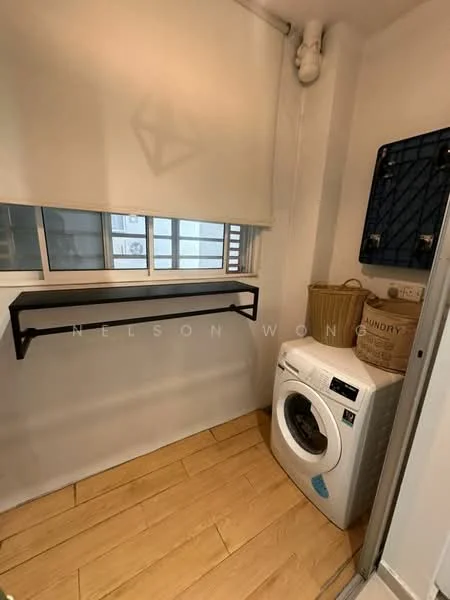 Laundry features: washer-dryer combo, wood-look vinyl flooring, white walls, black metal shelf, window with blinds, woven laundry basket, laundry area with space for folding, wall-mounted drying rack; style: modern.