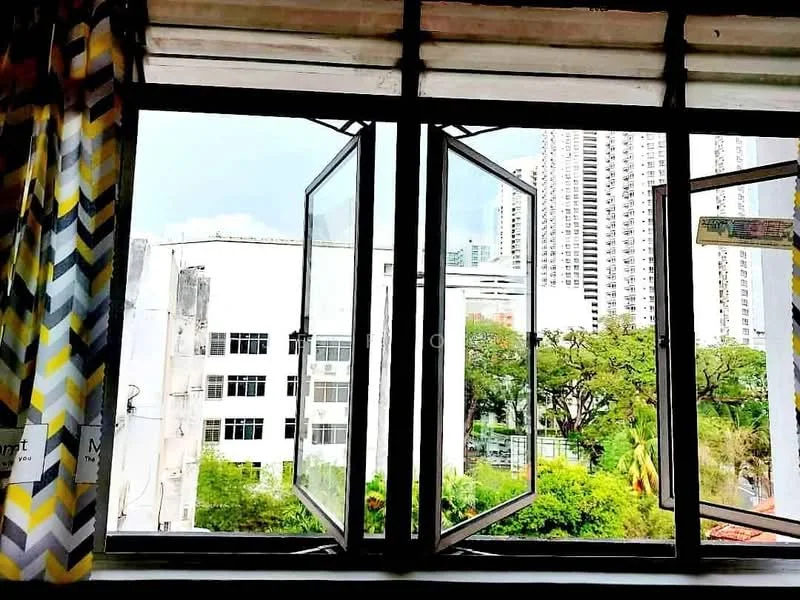 Room features: double casement windows, chevron patterned curtains in yellow, grey, and white, view of greenery outside, view of nearby buildings, natural light coming through windows; view: city.