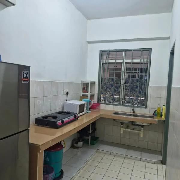 Kitchen features: stainless-steel fridge, built-in countertop, single-bowl stainless-steel sink, gas stove, microwave, white tiled walls, cream tiled flooring, window with security bars, cabinets under countertop, cleaning supplies on countertop, dish soap, sponge, water container.