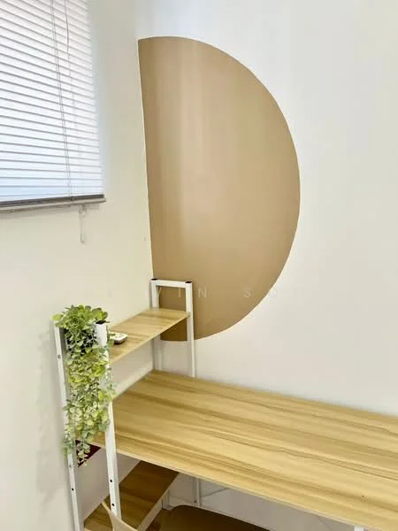 Room features: wooden desk, shelf unit, white walls, decorative wall with circular design, window with blinds, greenery decoration; style: modern.