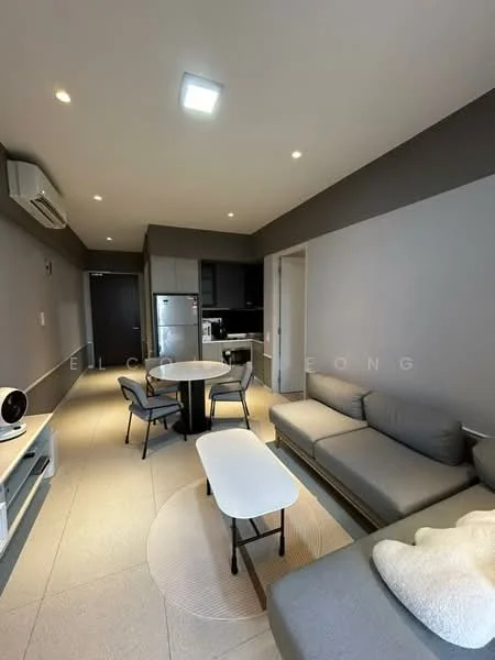 Living features: grey fabric sectional sofa, round coffee table, TV console, wall-mounted TV, recessed LED downlights, wall-mounted split AC, cream area rug, light grey painted walls, tile flooring, open layout to kitchen, dining table with chairs; style: modern. Kitchen features: stainless-steel fridge, built-in oven, black cabinetry, black countertop, ceramic tile backsplash, induction hob, sink, open layout to living area; style: modern.