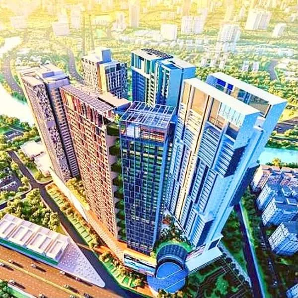 Exterior type: high-rise condominium; features: glass curtain wall, greenery on terraces, multiple recessed balconies, modern architectural design, surrounded by landscaped gardens, city skyline in background, varied building heights, open-air parking area, adjacent to waterway, urban context with nearby roads; style: modern.