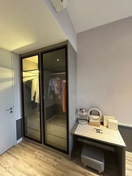 Room features: built-in wardrobe with sliding glass doors, wooden flooring, desk with chair, decorative mirror, wall-mounted air conditioning unit, neutral wall colour, clothing hanging in wardrobe, small decorative items on desk; style: modern.