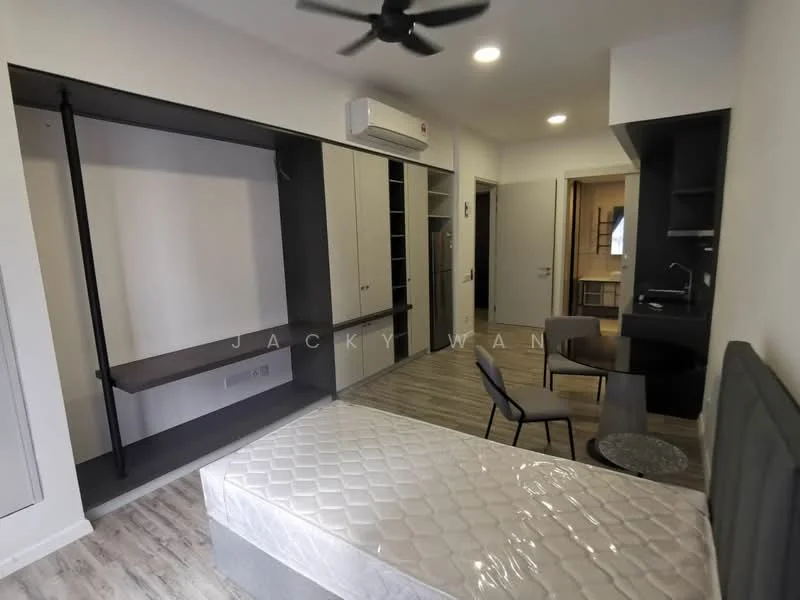 Room features: wooden flooring, white painted walls, ceiling fan, built-in wardrobe, open shelving, small dining table, two chairs, kitchenette with sink, refrigerator, wall-mounted air conditioning unit, bed frame without mattress, light fixtures, doorway leading to another room; style: modern.